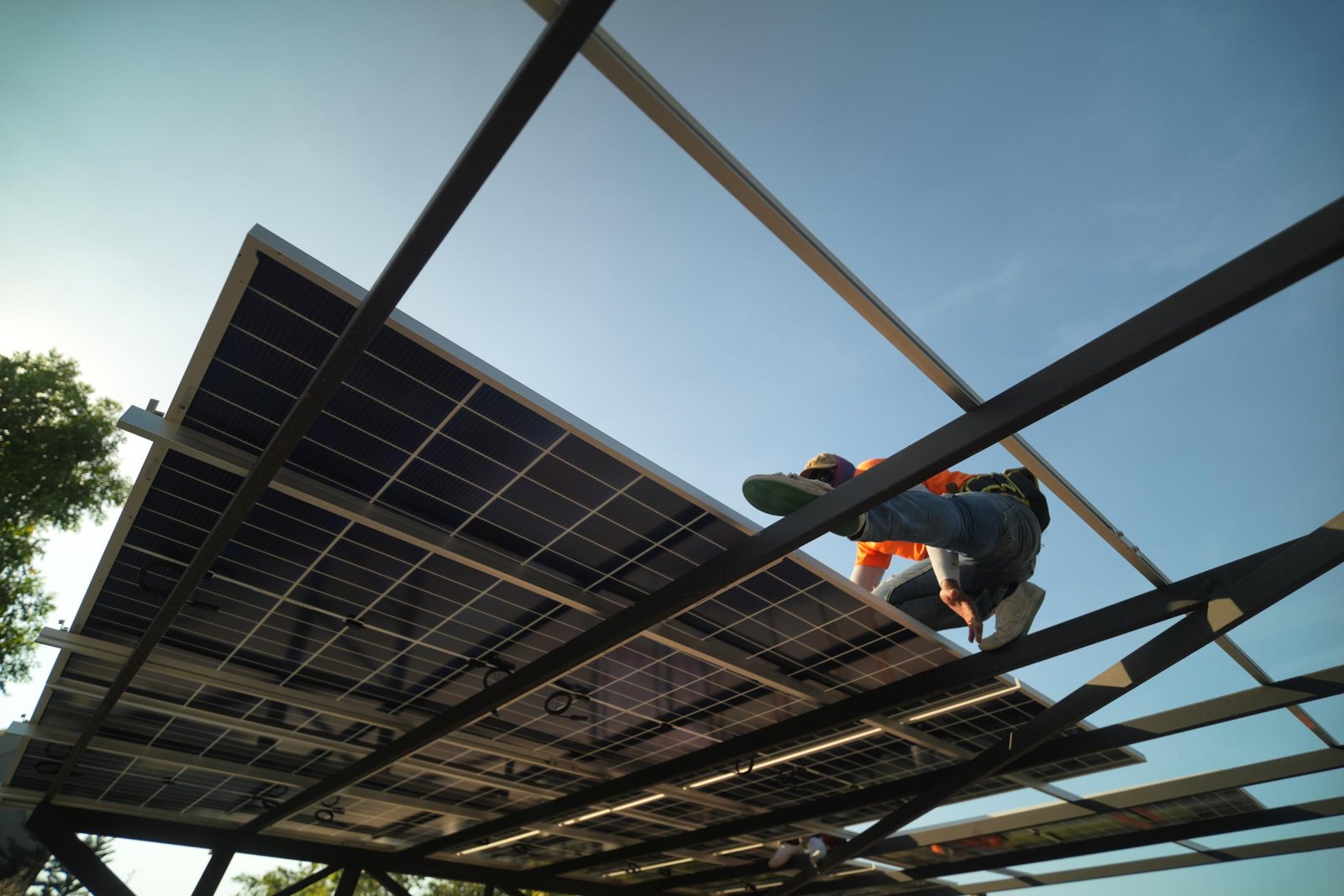 Technician installing photovoltaic structures during the assembly of solar panels