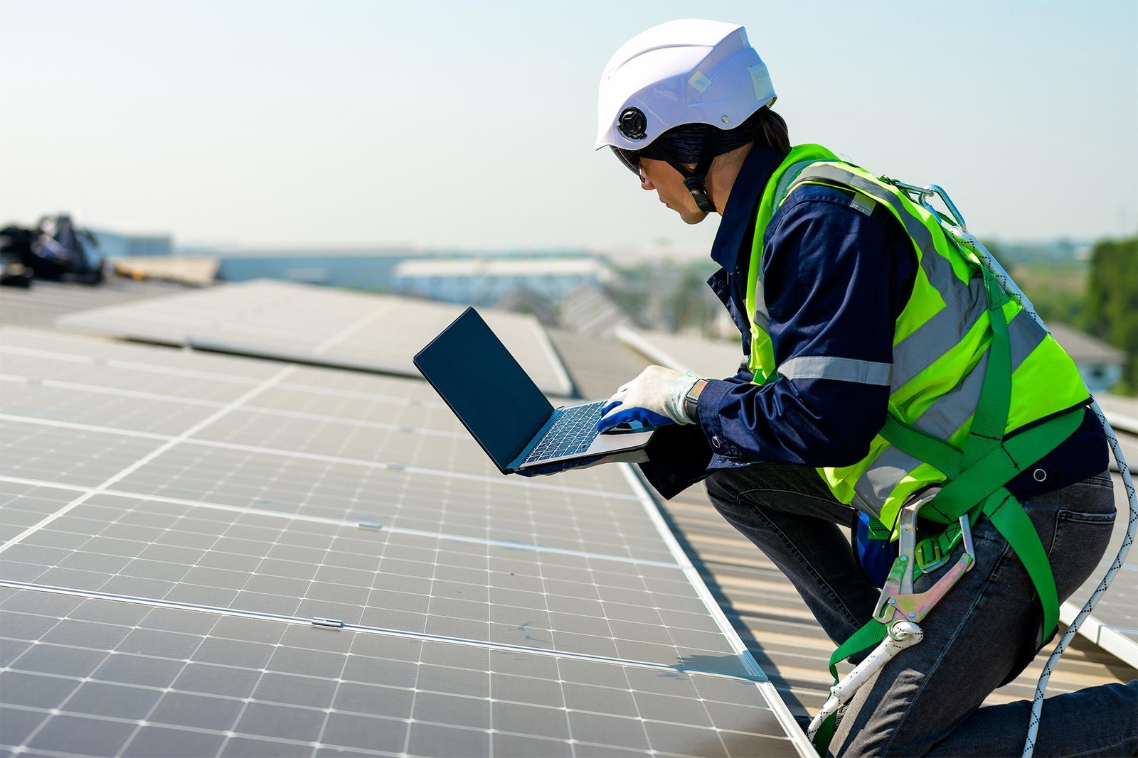 Technician inspecting solar panels and verifying photovoltaic structures on an industrial roof
